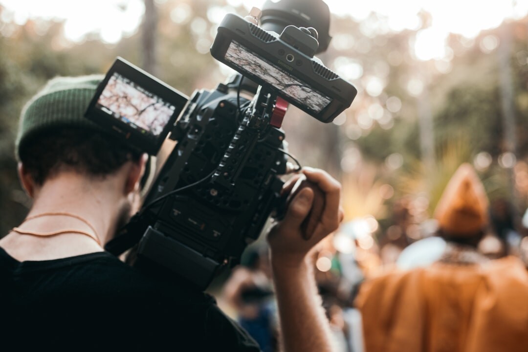 Camera operator filming a live outdoor broadcast event