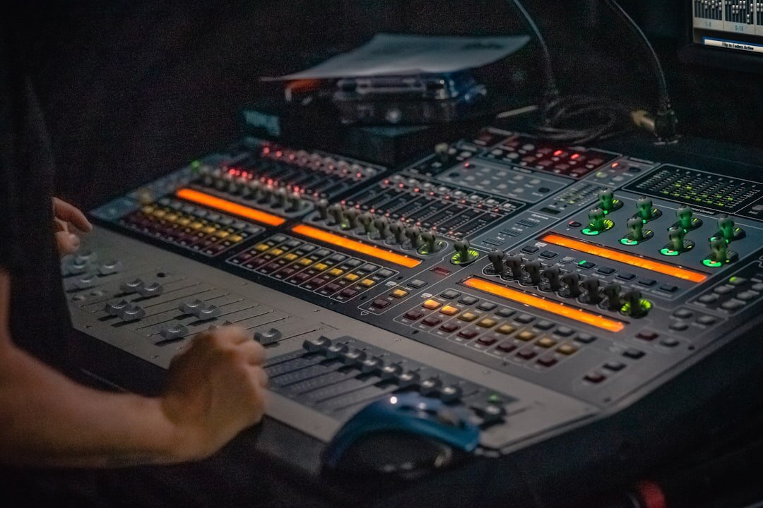 Technical director operating a video switcher desk with multiple faders